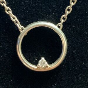 DELICATE STERLING CIRCLE PENDANT WITH FACETED CZ CHIP.